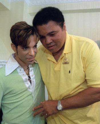 Boxing great Muhammad Ali, right, embraces the Artist Formerly Known as Prince, during a meeting in Washington on June 24, 1997 prior to a news conference where they were to announce plans for a benefit concert in October. (AP Photo/Karin Cooper/Rogers & Cowan)