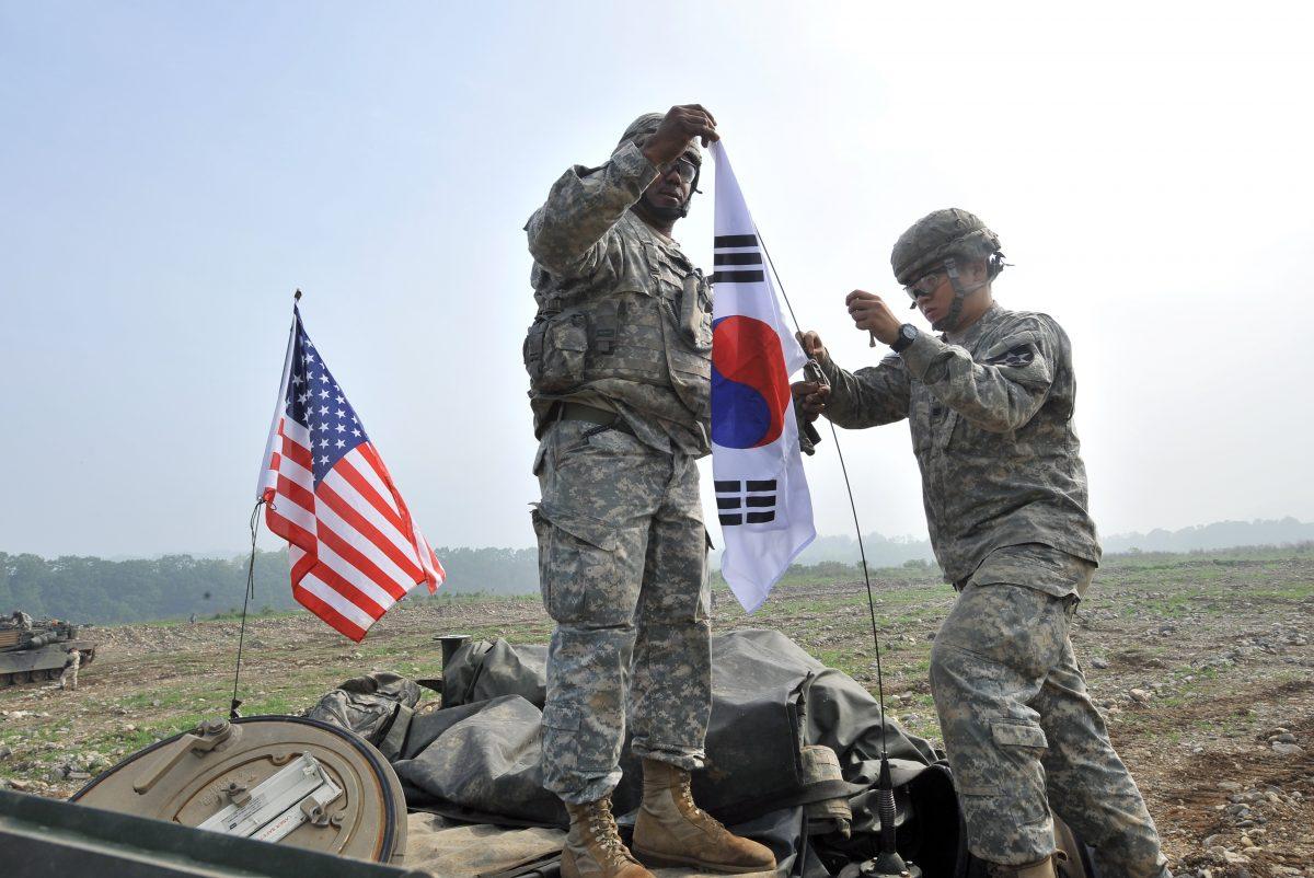 U.S. soldiers from 2nd Infantry Division hang a South Korean flag on the top of their M1A2 tank during a U.S.-South Korea joint river crossing exercise in the border city of Yeoncheon, northeast of Seoul, on May 30, 2013. (Jung Yeon-je/AFP/Getty Images)