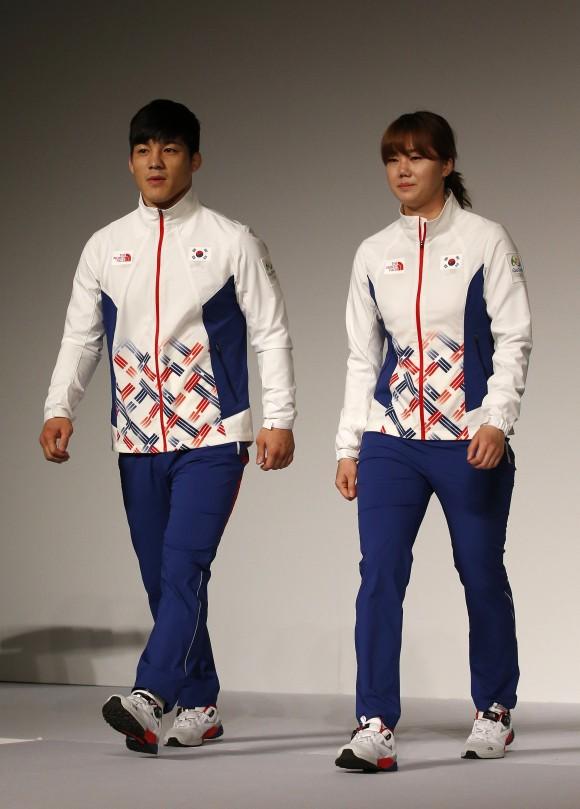 South Korean Olympic wrestling athlete Kim Hyeon-woo, left, and handball athlete Kim On-a, right, present the South Korean Olympic team uniforms for the medal ceremony of the 2016 Rio de Janeiro Olympic Games at Korean National Training Center in Seoul, South Korea, April 27, 2016. (AP Photo/Lee Jin-man)