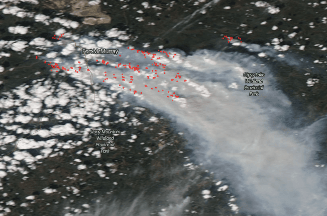 A May 5, 2016, satellite image of Fort McMurray with fires or heat anomalies marked in red. (Screenshot of NASA Worldview)