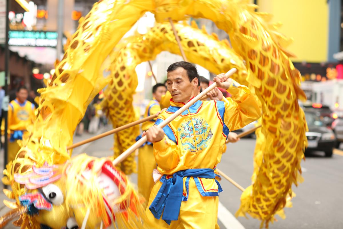 A Chinese dragon team performs in the World Falun Dafa Day parade in New York on May 13, 2016. Over 8,000 supporters of Falun Gong participated in the march that started near the United Nations and ended at the Chinese consulate building. (Benjamin Chasteen/Epoch Times)