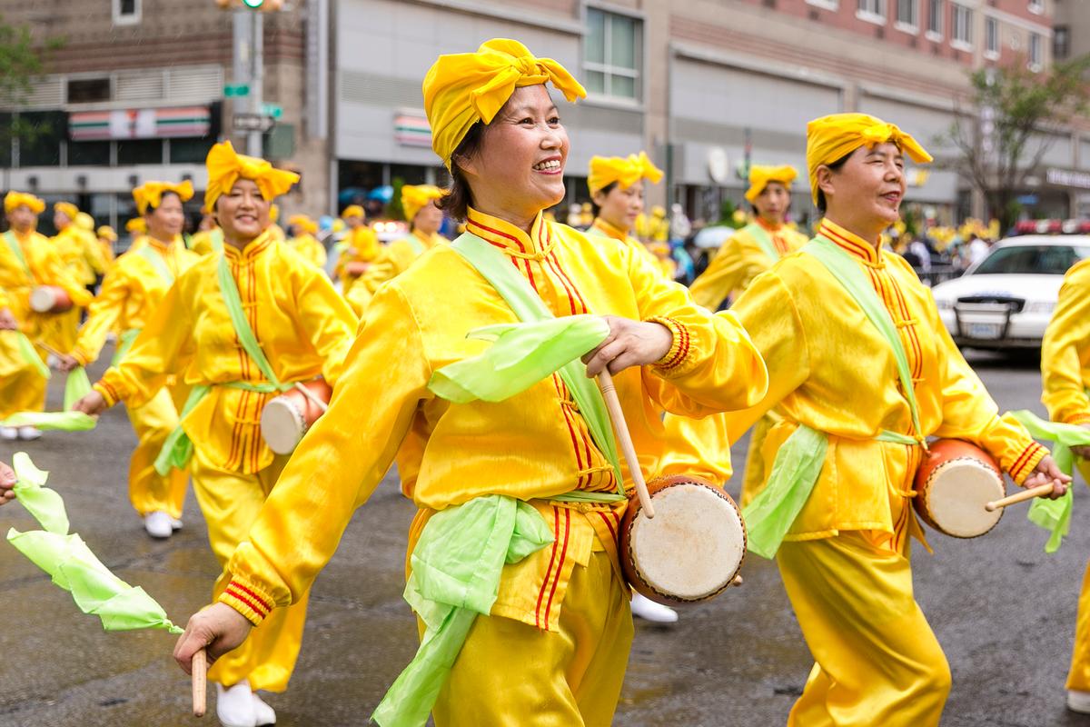 A Falun Gong waist drum troupe performs in the World Falun Dafa Day parade along 42nd Street in New York, on May 13, 2016. (Samira Bouaou/Epoch Times)