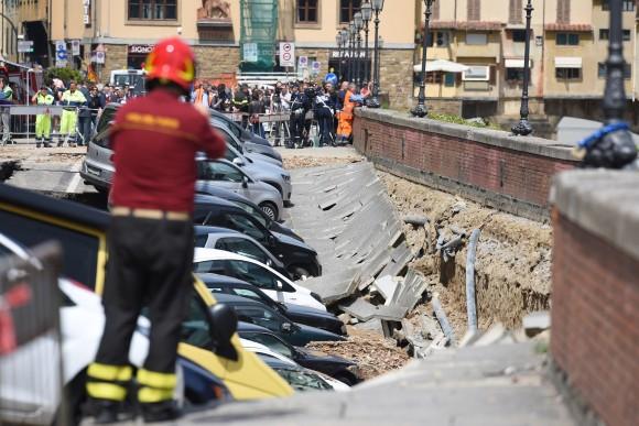 A picture shows damaged cars along the Arno river where the embankment collapsed early on May 25, 2016 in central Florence. The damage, stretching between the 14th century Ponte Vecchio and the Ponte alle Grazie, affected about 200 metres of the embankment in total. Emergency services said the collapse was due to a water pipe break and authorities stopped traffic along the road. (CLAUDIO GIOVANNINI/AFP/Getty Images)