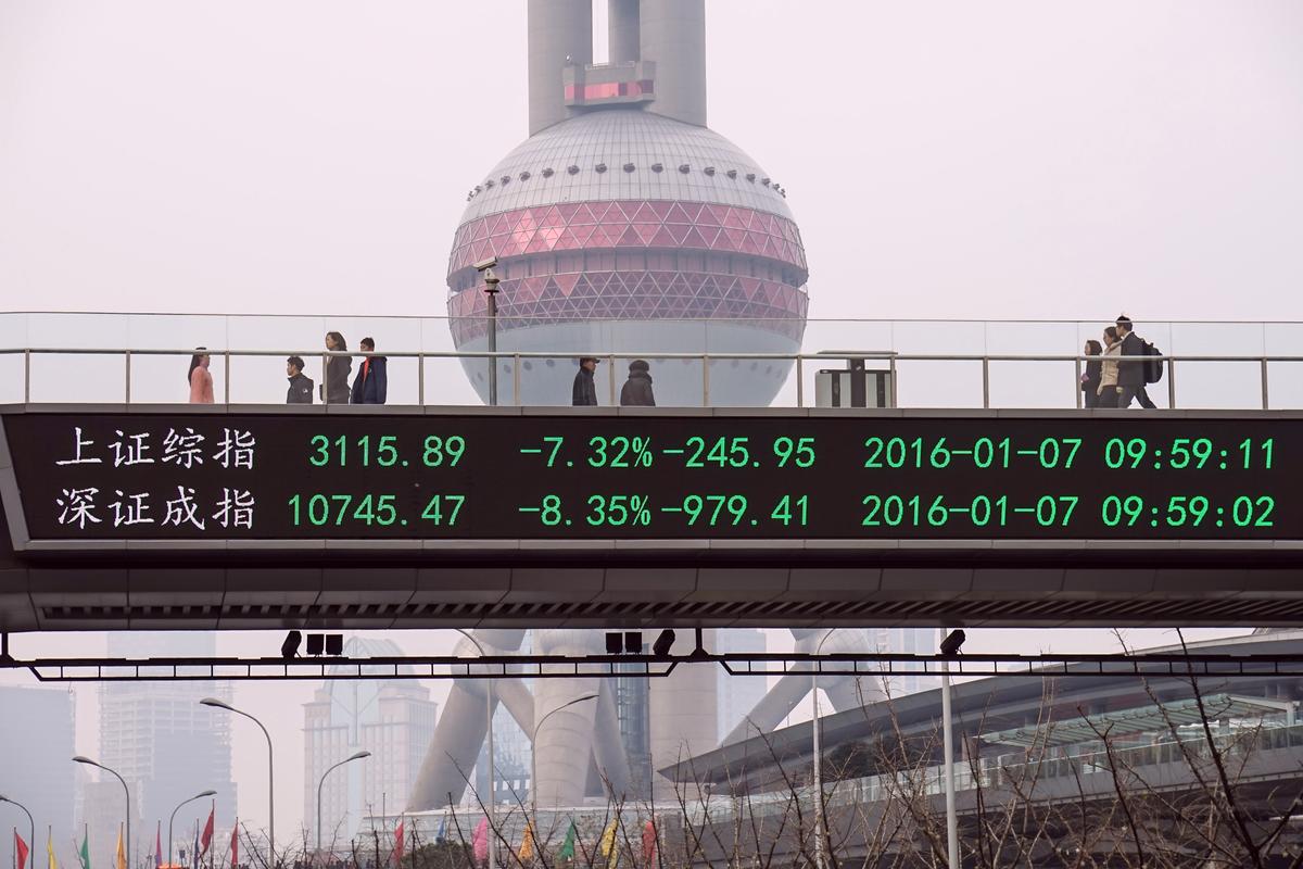 A stock ticker screen in Shanghai shows indices of Shanghai Stock Exchange and Shenzhen Stock Exchange on Jan. 7. (STR/AFP/Getty Images)