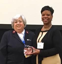 Lt. Col. Ardis Fuga (L) gives a Salvation Army Award to Paula Coppin operating supervisor of Consumer Outreach for Central Gas & Electric, Inc. during the National Energy Utility and Affordability conference in Denver, Colo. in June. (Courtesy Central Hudson Utility)