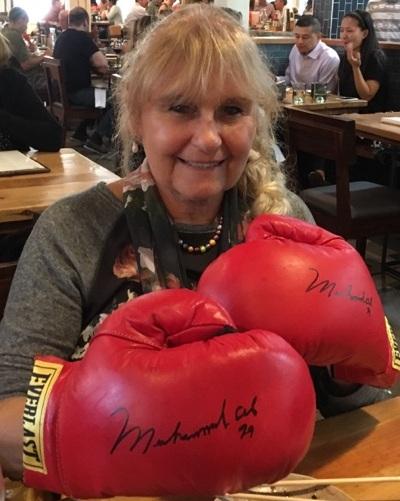 <br/> Lina wearing boxing gloves autographed by Ali. (Courtesy of Bruce Barton)