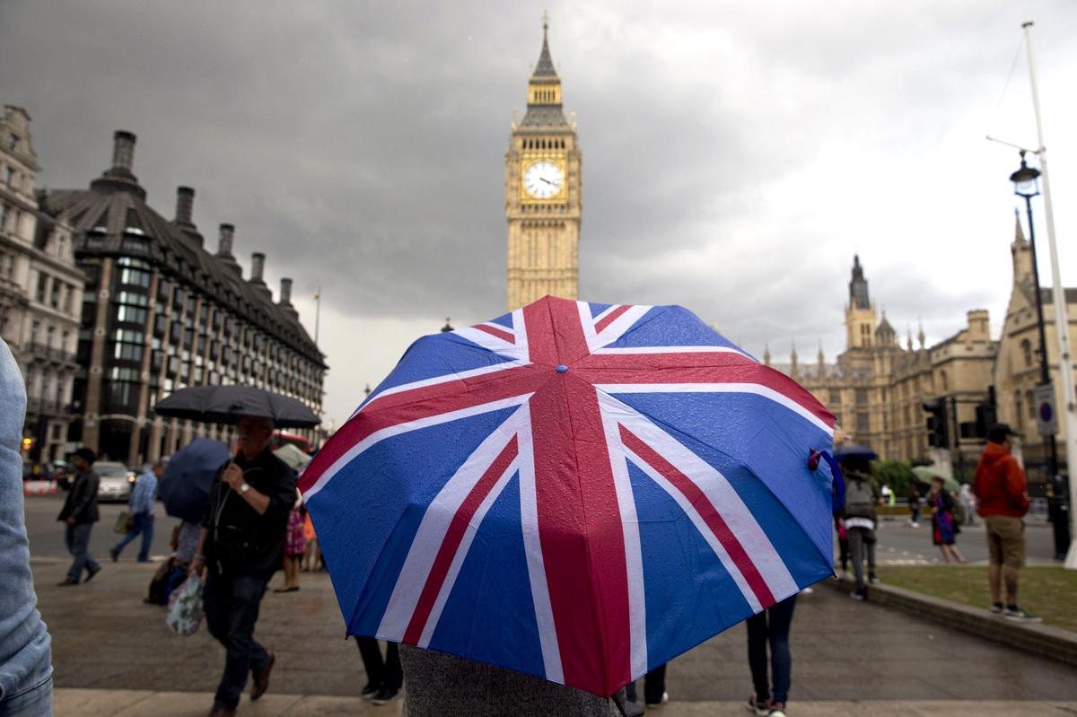 BREXIT A pedestrian shelters from the rain with an Union Jack-themed umbrella in London on June 25, the day after Britain voted in a referendum to leave the European Union. (Justin Tallis/AFP/Getty Images)