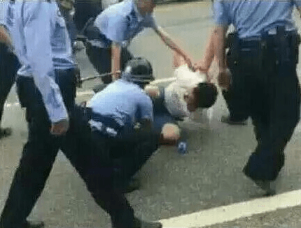 Hubei police attacking a demonstrator. (Screenshot via Youtube)