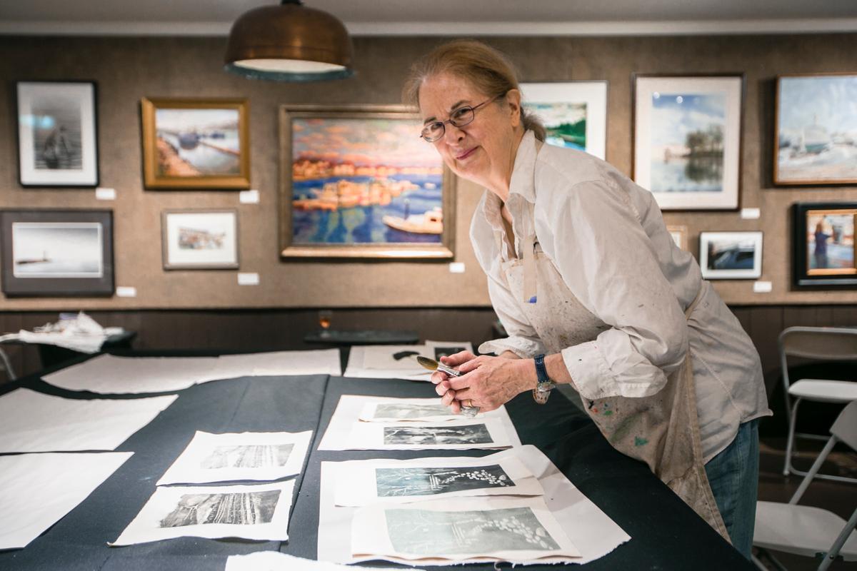 Annie Shaver-Crandell looks at her prints at the Monotype Party of the Salmagundi Club on July 12, 2016. (Samira Bouaou/Epoch Times)