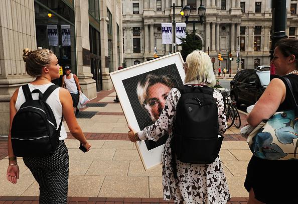 Women walk down a Philadelphia street with a Chuck Close portrait of Hillary Clinton on the first day of the Democratic National Convention (DNC) on July 25, 2016 in Philadelphia, Pennsylvania. (Spencer Platt/Getty Images)