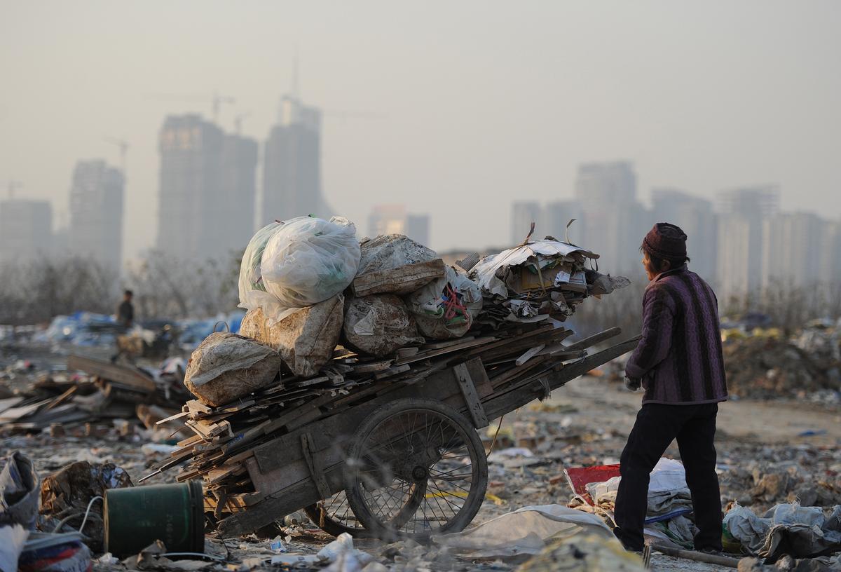 A scavenger picks up useful construction waste from a garbage dump in Hefei, Anhui Province on Dec. 9, 2012. (STR/AFP/Getty Images)