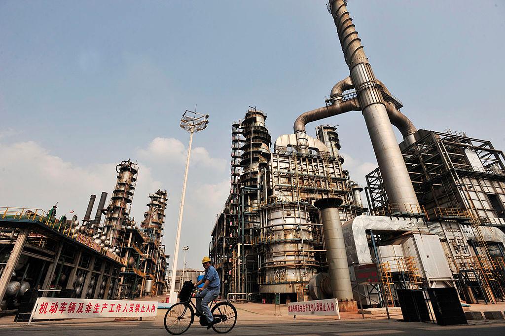 A worker rides bicycle at an oil refinery of China's Sinopec in Wuhan, a city in China's Hubei Province on May 10, 2011. (STR/AFP/Getty Images)