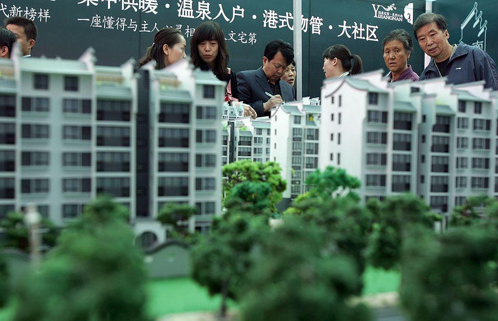 Visitors view architects' models of apartment blocks during the 2007 Xian Autumn Real Estate Trade Fair in Xian of Shaanxi Province on Oct. 26, 2007. (China Photos/Getty Images)
