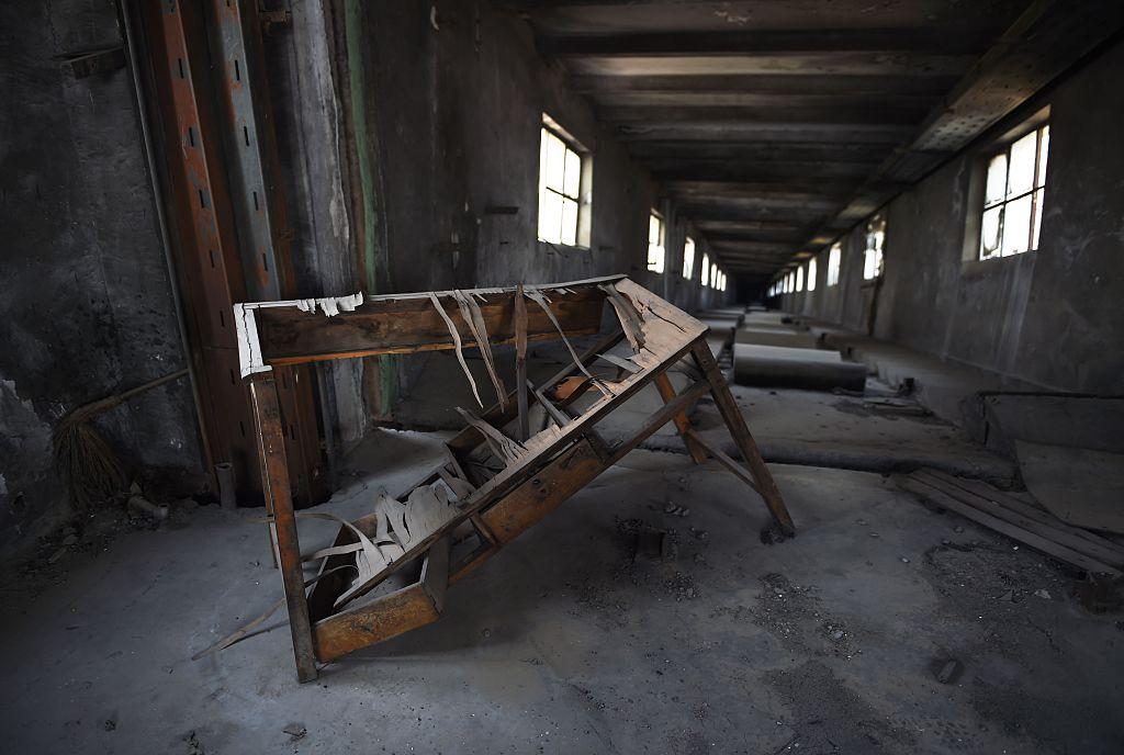 A broken desk is seen at the top of an enclosed conveyer belt at an abandoned chemical factory on the outskirts of Beijing on April 4, 2016. (Greg Baker/AFP/Getty Images)
