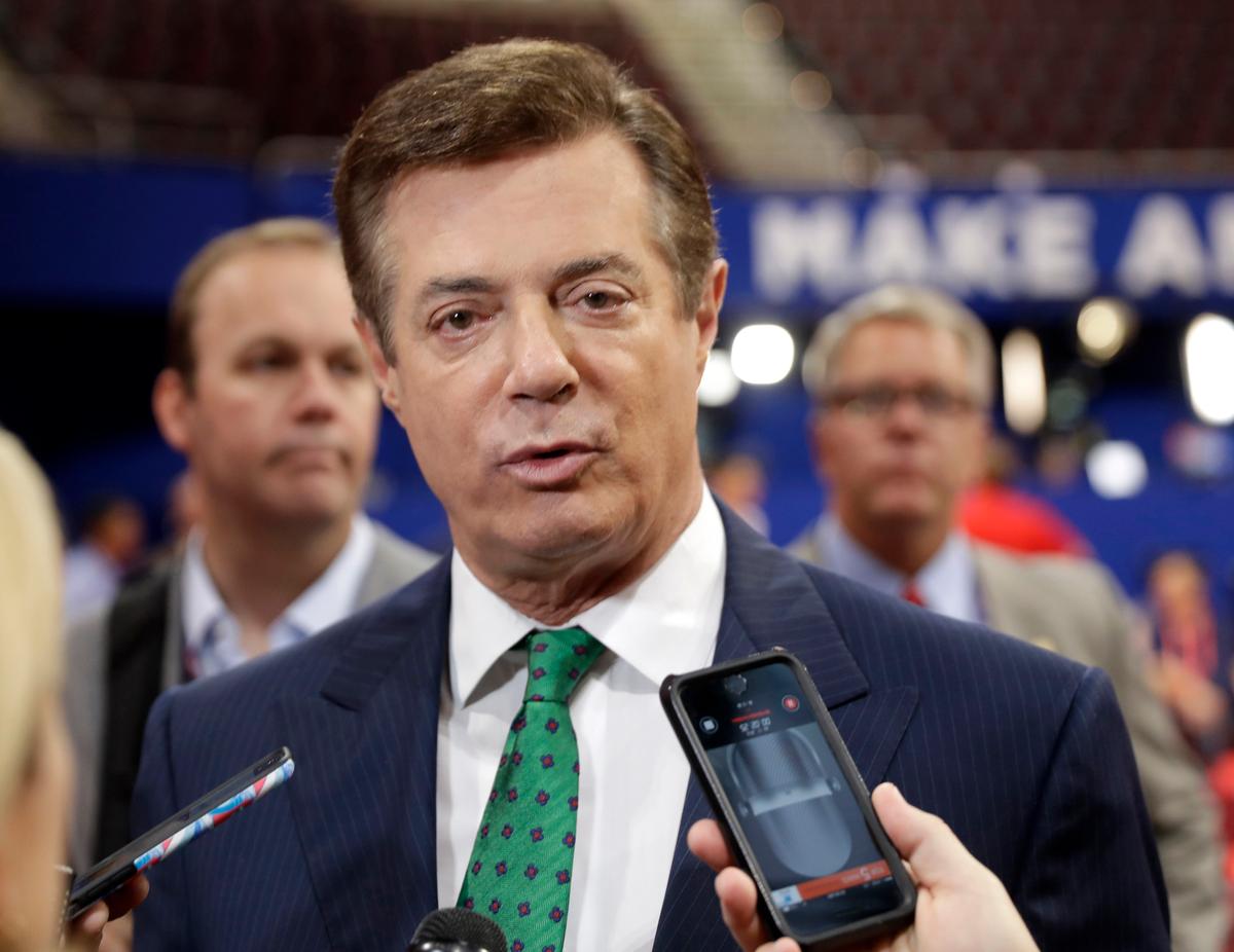 Paul Manafort talks to reporters on the floor of the Republican National Convention at Quicken Loans Arena in Cleveland on July 17, 2016. (AP Photo/Matt Rourke)