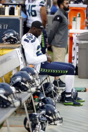 Seattle Seahawks cornerback Jeremy Lane sits as the national anthem plays before a preseason NFL football game against the Oakland Raiders Thursday, Sept. 1, 2016, in Oakland, Calif. (AP Photo/Tony Avelar)