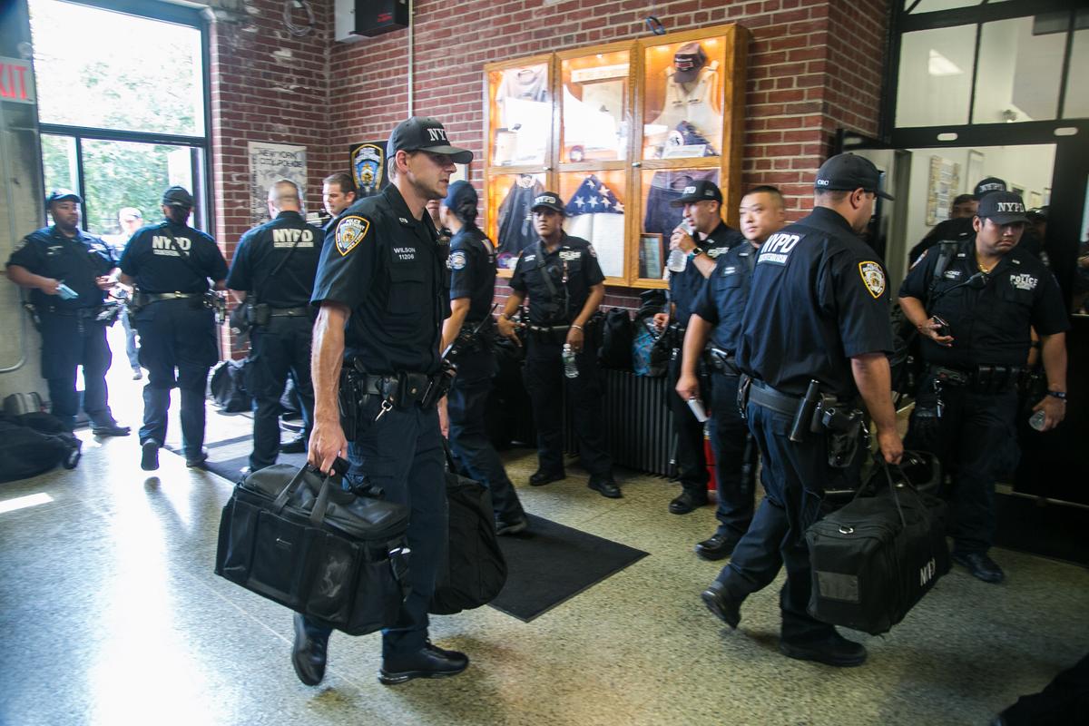 Officers of the NYPD Counterterrorism Bureau return from their shifts, while others prepare to start theirs, at their headquarters on Randall's Island in New York on Aug. 11, 2016. (Benjamin Chasteen/Epoch Times)