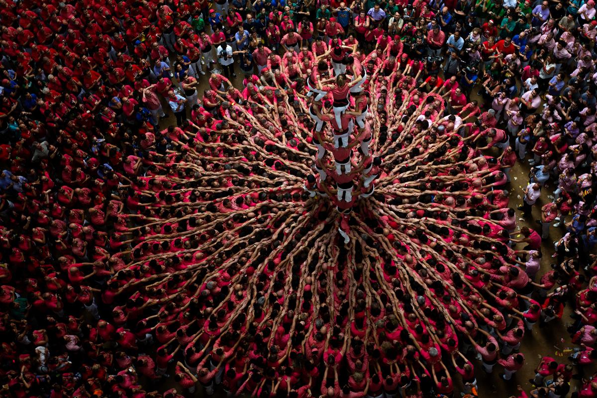 Members of Vella de Xiquets de Valls try to complete their human tower during the Human Tower Competition in Tarragona, Spain, on Oct. 2. The tradition of building human towers, or Castells, dates back to the 18th century and takes place during festivals in Catalonia, where "colles", or teams, compete to build the tallest and most complicated towers. (AP Photo/Emilio Morenatti)