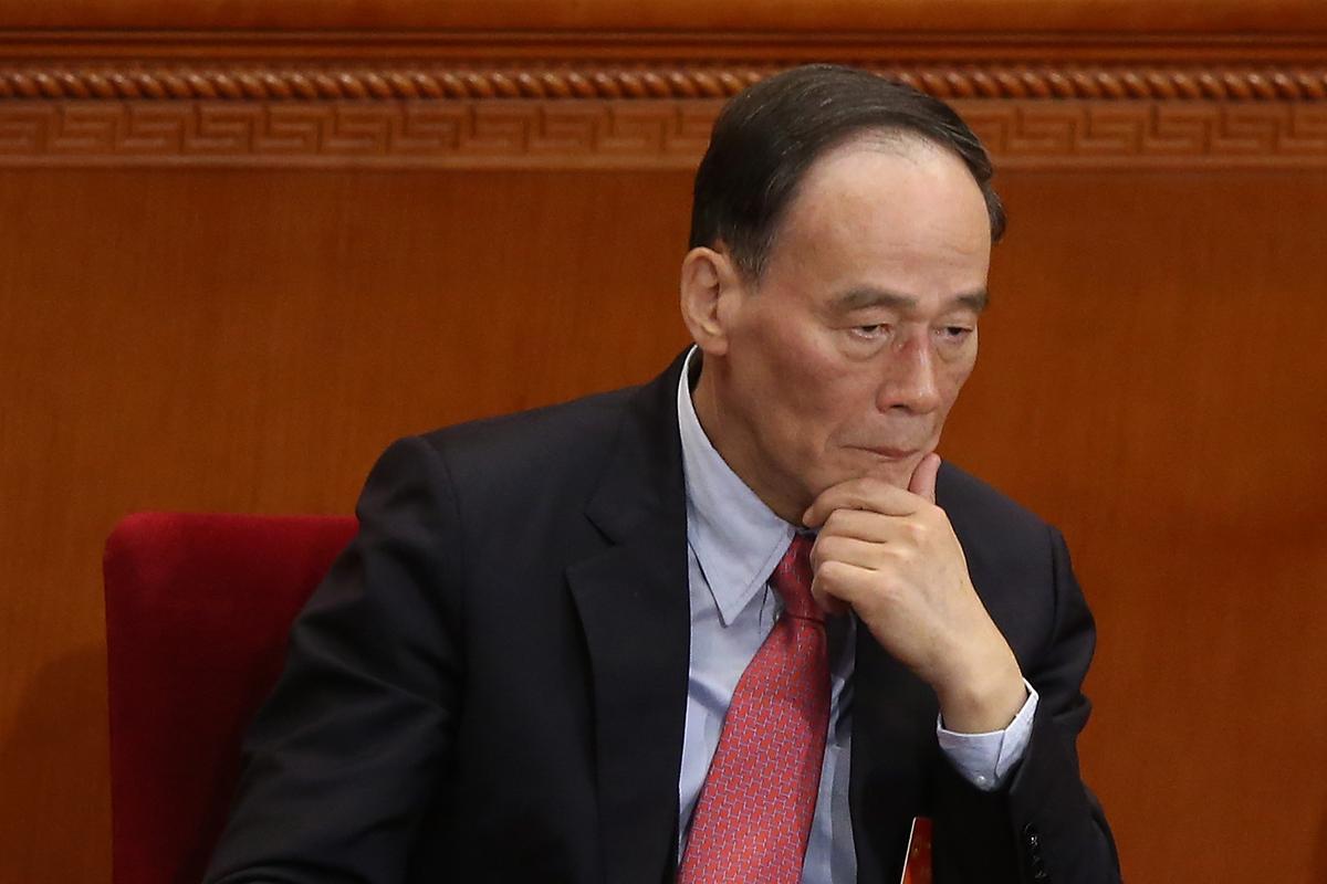 Anti-corruption chief Wang Qishan at the Great Hall of the People in Beijing on March 5, 2014. Recently, anti-corruption investigators criticized the 610 Office, an extralegal Party organization that oversees the persecution of Falun Gong, in a feedback report. (Feng Li/Getty Images)