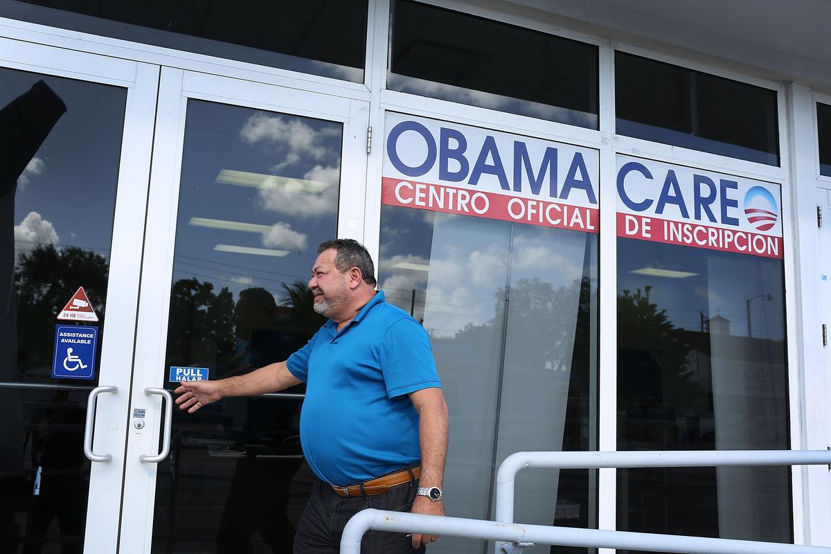A person walks into the UniVista Insurance company office where people are signing up for health care plans under the Affordable Care Act, also known as Obamacare, in Miami on Dec. 15, 2015. (Joe Raedle/Getty Images)