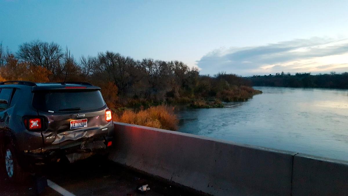 A damaged car is shown on an Interstate 84 bridge over the Snake River on the Idaho/Oregon border near Ontario, Ore., on Nov. 21, 2016. (Oregon State Police via AP)