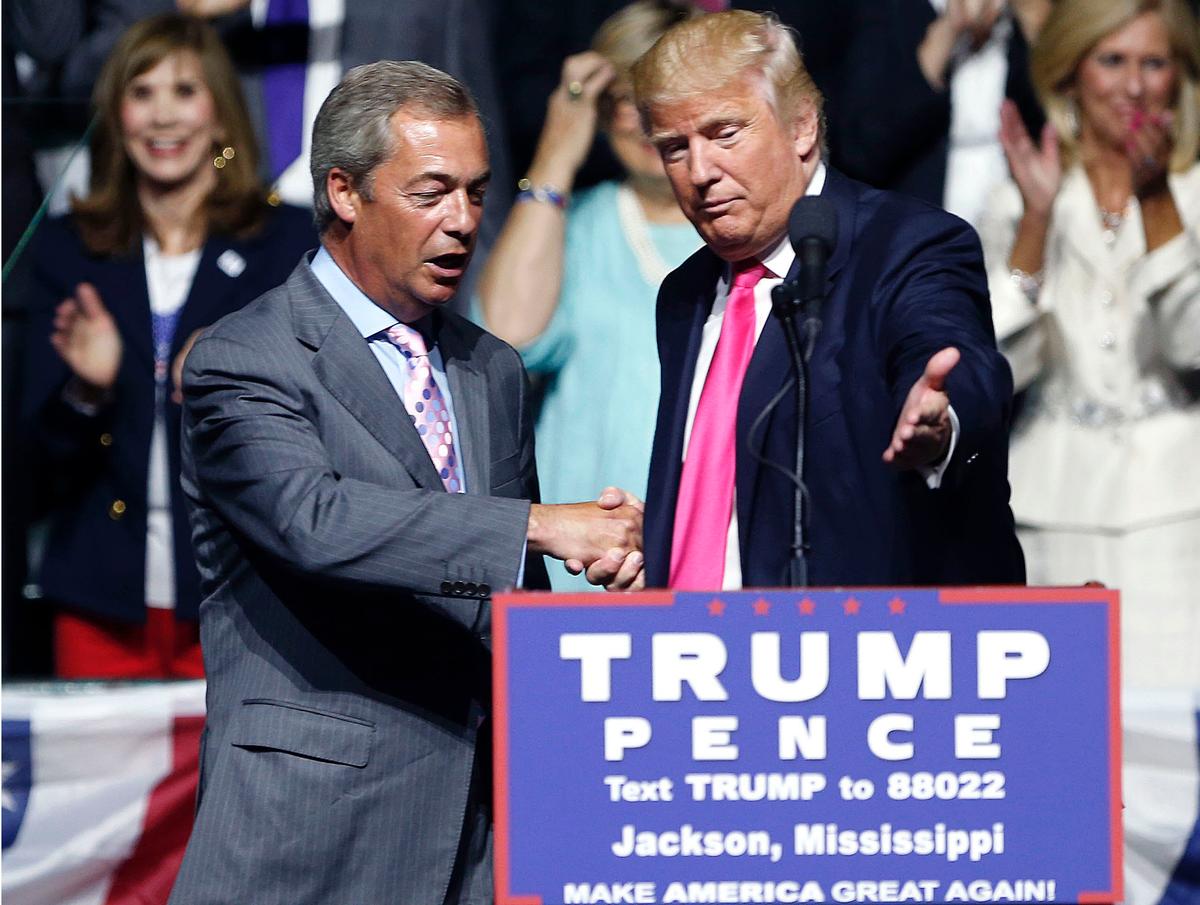 Then-Republican presidential candidate Donald Trump (R) welcomes pro-Brexit British politician Nigel Farage, to speak at a campaign rally in Jackson, Miss., in this file photo. (AP Photo/Gerald Herbert, File)