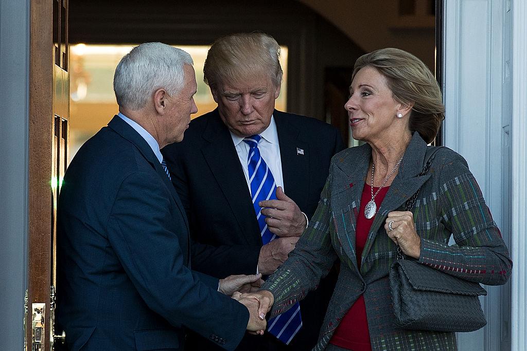 (L to R) Vice president Mike Pence, President Donald Trump and Betsy DeVos leave the clubhouse after their meeting at Trump International Golf Club, in Bedminster Township, NJ., on Nov. 19, 2016. (Photo by Drew Angerer/Getty Images)