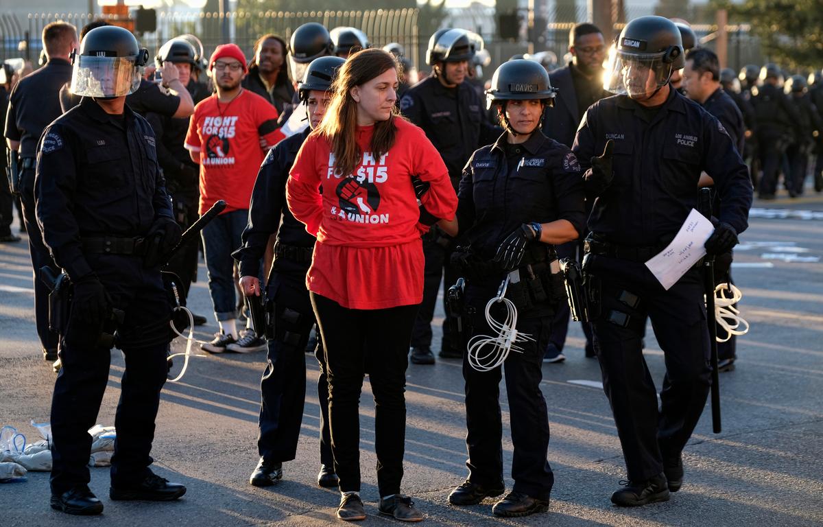 Protesters are arrested and taken into custody during a wage protest in downtown Los Angeles on Nov. 29, 2016. (AP Photo/Richard Vogel)