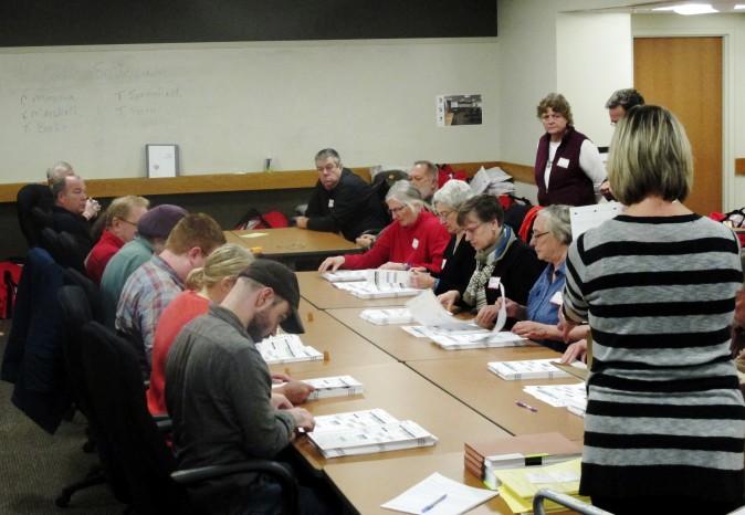 Ballots from the town of Middleton, Wis., are placed in front of workers as a statewide presidential election recount begins, in Madison, Wis., on Dec. 1, 2016. (AP Photo/Scott Bauer)