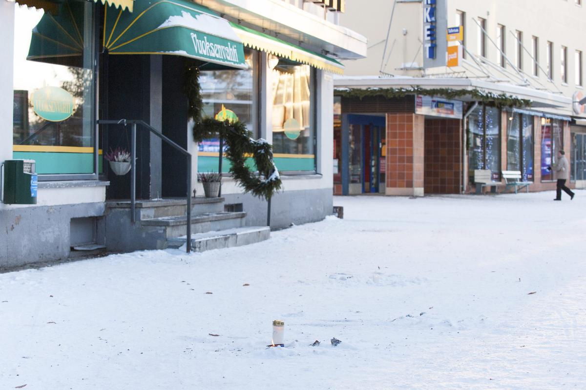 A candle is laid in front of the restaurant Vuoksenvahti where three women were killed, in Imatra, Finland on Dec. 4, 2016. (Hannu Rissanen/Lehtikuva via AP)