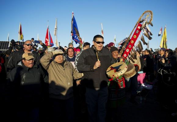 A Native American drum procession moves through the Oceti Sakowin camp after it was announced that the U.S. Army Corps of Engineers won't grant easement for the Dakota Access oil pipeline in Cannon Ball, N.D., on Dec. 4, 2016. (AP Photo/David Goldman)