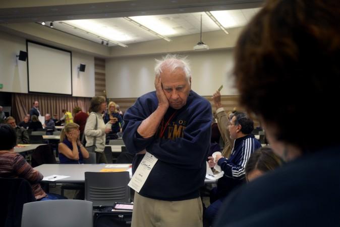 Burke Cueny, of Rochester, watches as volunteers and city officials participate in a recount after a federal judge ordered the statewide recount at the Oakland Schools Conference Center in Waterford Township, Michigan on Dec. 5, 2016. Three people have now filed a lawsuit to get a hand recount in Florida. (Rachel Woolf/Getty Images)