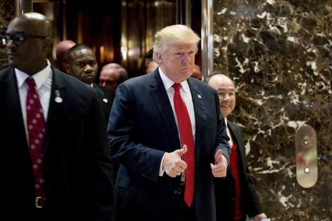 President-elect Donald Trump and SoftBank Chief Executive Officer Masayoshi Son, right, walk into the lobby to speak to members of the media at Trump Tower in New York on Dec. 6, 2016. (AP Photo/Andrew Harnik)
