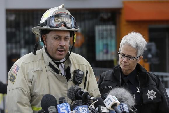 Oakland fire deputy chief Darren White, left, speaks next to Oakland Police officer Johnna Watson at a news conference near the site of a warehouse fire in Oakland, Calif., on Dec. 6, 2016. (AP Photo/Jeff Chiu)