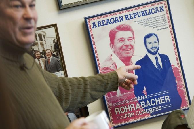 Rep. Dana Rohrabacher, R-Calif., talks about a campaign poster with his image alongside Ronald Reagan's while giving a tour of his Rayburn Building office to Roll Call. (Tom Williams/Roll Call) (CQ Roll Call via AP Images)