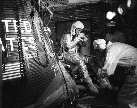 In this Feb. 20, 1962, file photo, astronaut John Glenn sits next to the Friendship 7 space capsule atop an Atlas rocket at Cape Canaveral, Fla., during preparations for his flight which made him the first American to orbit the Earth. Glenn, who later spent 24 years representing Ohio in the Senate, has died at 95. (AP Photo/File)