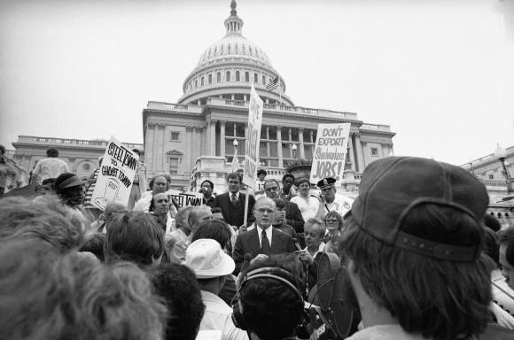 In this Friday, Sept. 23, 1977 file photo, Sen. John Glenn, D-Ohio, center, speaks to a group of Youngstown, Ohio Steelworkers on the steps of the Capitol in Washington. The group urged the government to curb steel imports and to relax pollution control requirements. Glenn, the first U.S. astronaut to orbit Earth who later spent 24 years representing Ohio in the Senate, died Thursday, Dec. 8, 2016, at the age of 95. (AP Photo/Harvey Georges, File)