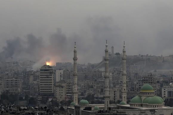 In this file photo, a ball of fire rises following an air strike hits insurgents positions in eastern neighborhoods of Aleppo, Syria. (AP Photo/Hassan Ammar, File)