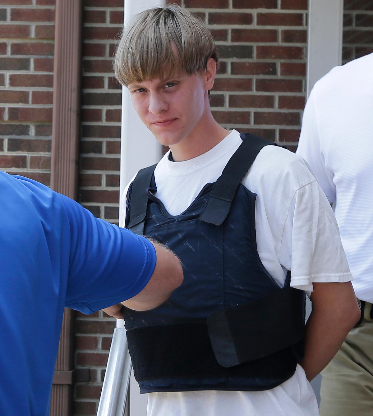 Dylann Storm Roof is escorted from the Sheby Police Department in Shelby, N.C., in this file photo. (AP Photo/Chuck Burton)