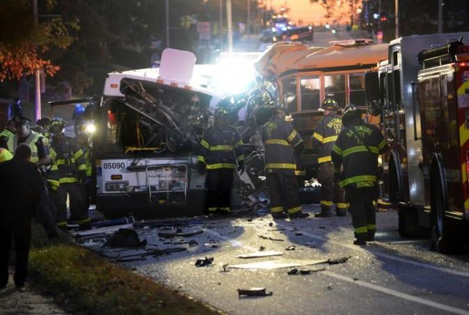 In this Tuesday, Nov. 1, 2016, file photo, fire department and rescue officials work at the scene of an early morning fatal collision between a school bus and a commuter bus in Baltimore.  (Jeffrey F. Bill/The Baltimore Sun via AP, File)