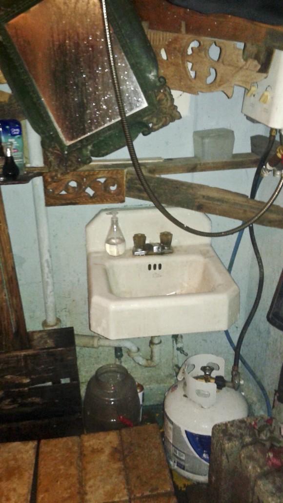 In photo provided by Shelley Mack, a fuel tank sits under a sink in a make shift communal bathroom at the Ghost Ship warehouse in Oakland, Calif., on Jan. 30, 2015. (Shelley Mack via AP)