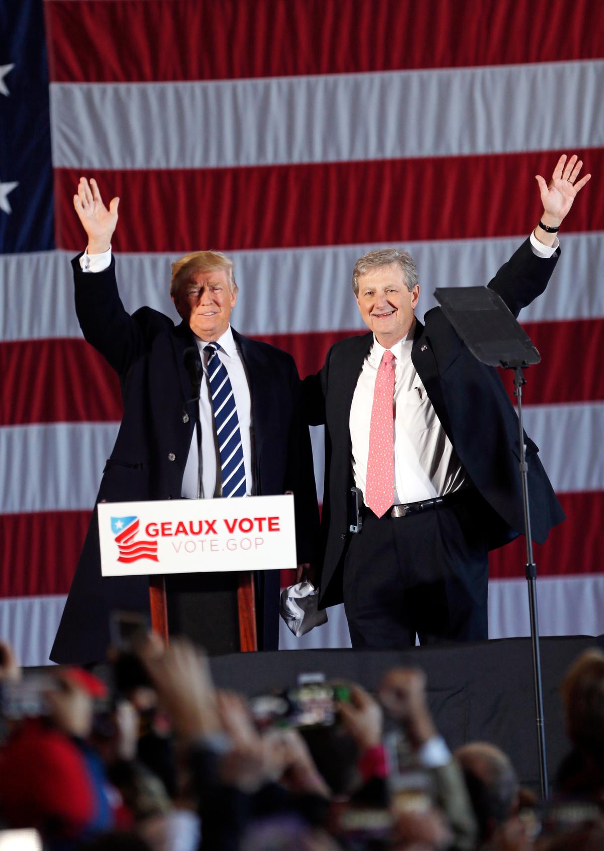 President-elect Donald Trump arrives onstage with Republican senate candidate, Louisiana Treasurer John Kennedy, to speak at a "Get Out The Vote" rally in Baton Rouge, La., on Dec. 9, 2016. (AP Photo/Gerald Herbert)