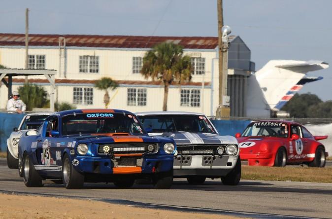 A classic Trans-Am battle recreated: the #45 1966 Ford Mustang and the #81 1967 Chevy Camaro, both cars driven in turns by Ben Beighton, Chris Beighton, and Alec Hammond, fight their way through Turn Three. (Chris Jasurek/Epoch Times)