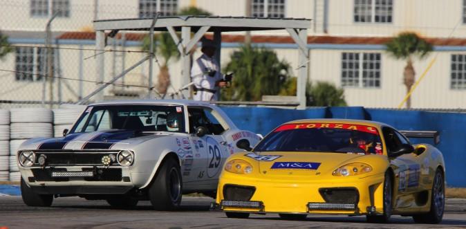 A duel which could only happen at an historic race: Ken Marlin and Peter Argetsinger's #15 2000 Ferrari 360 cuts under Oliver and Bryant Grahame's 1967 Chevy Camaro Z/28. (Chris Jasurek/Epoch Times)