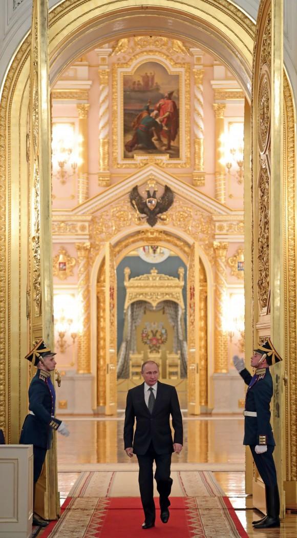 Russian President Vladimir Putin enters a hall to attend a reception marking Heroes of the Fatherland Day in the Kremlin in Moscow, Russia on Dec. 9, 2016. (Mikhail Klimentyev/Sputnik, Kremlin Pool Photo via AP)
