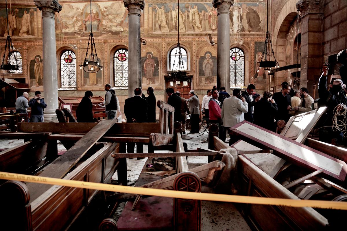 Security forces examine the scene inside the St. Mark Cathedral in central Cairo, following a bombing on Dec. 11, 2016. (AP Photo/Nariman El-Mofty)