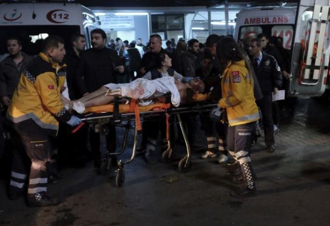 Rescue and medics carry a wounded person after attacks in Istanbul, late Saturday, Dec. 10, 2016. (AP Photo/Cansu Alkaya)