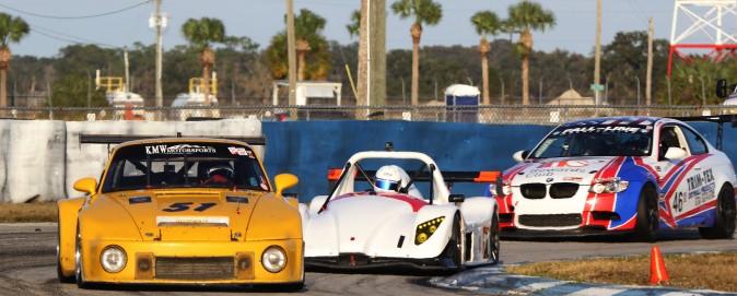 A 1975 Porsche leads two modern cars around Turn Three. Confrontations like this are the specialty of historic racing. (Chris Jasurek/Epoch Times)