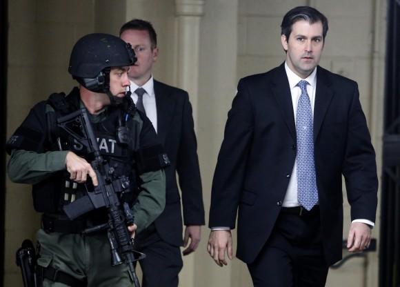 Michael Slager, at right, walks from the Charleston County Courthouse under the protection from the Charleston County Sheriff's Department after a mistrial was declared for his trial, inin Charleston, S.C., on Dec. 5, 2016. (AP Photo/Mic Smith)