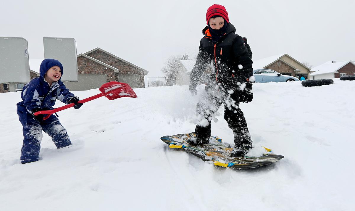 Children play in the snow in Asbury, Iowa, on Dec. 11, 2016. (Nicki Kohl/Telegraph Herald via AP)